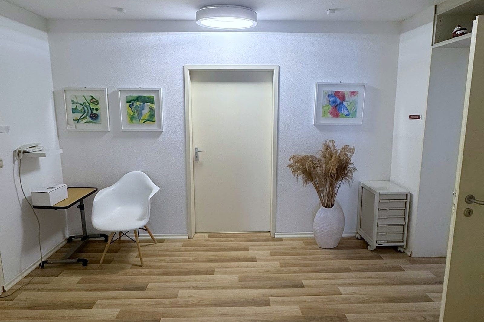 Bright hallway with pictures on the wall and seating