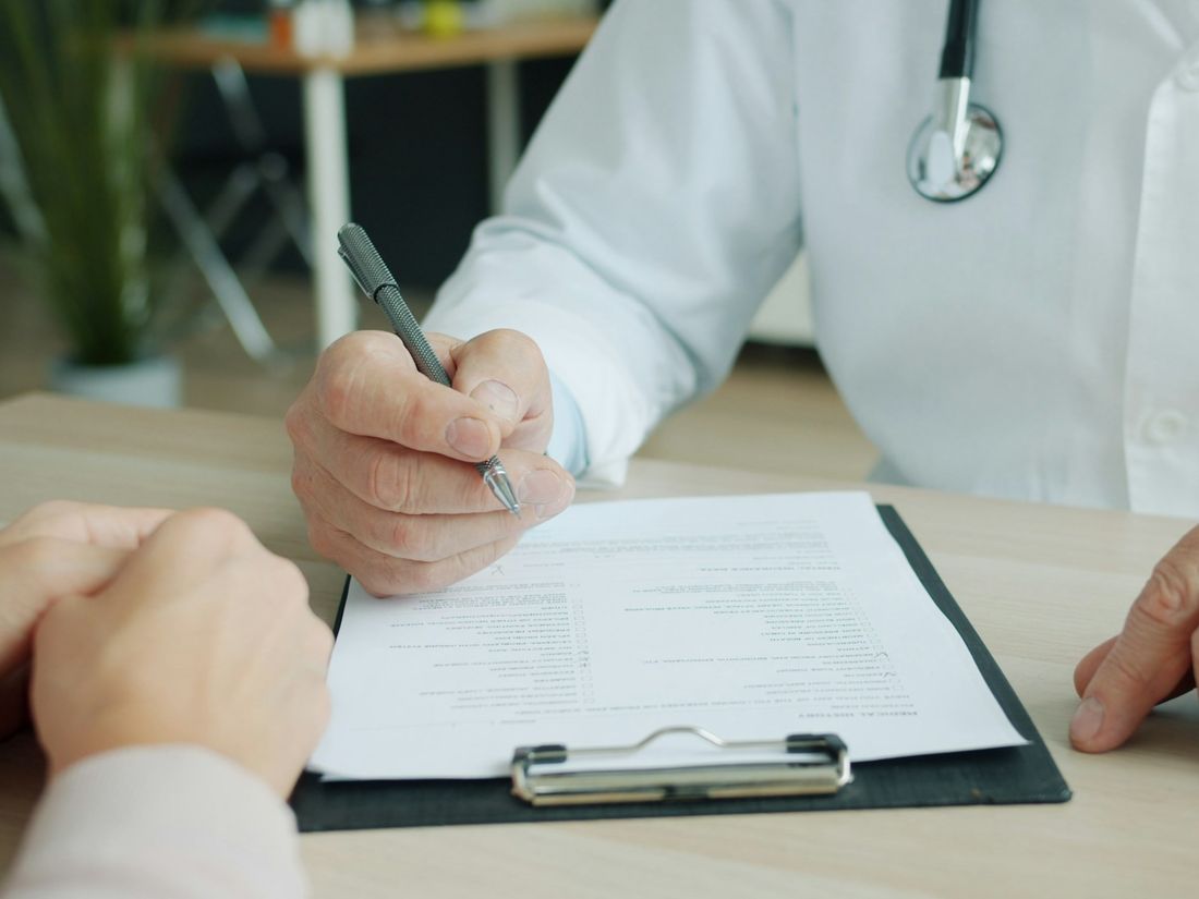 Doctor talking with a patient about their health history